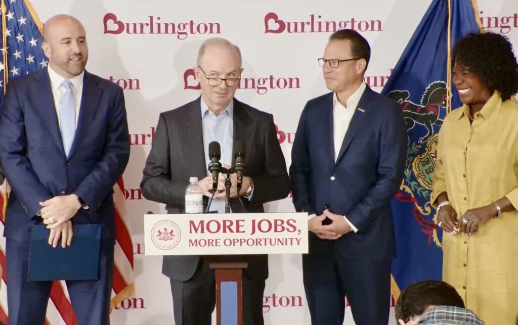 burlington-presser-shapiro-090326 Burlington Stores CEO Michael O’Sullivan, center, speaks at a news conference at Schuylkill Yards