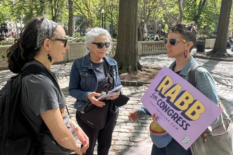 A Reclaim Philadelphia member speaks with two people