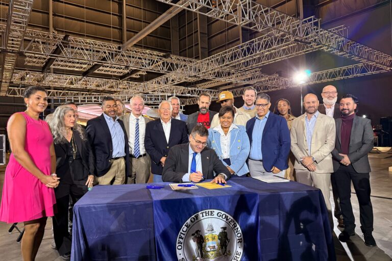 Matt Meyer signs legislation alongside others