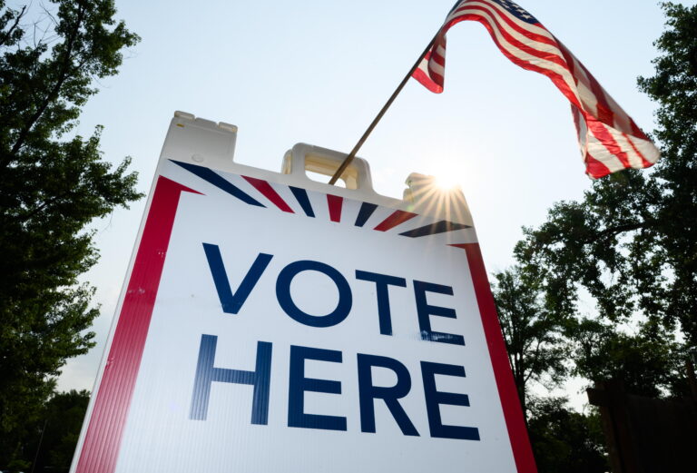 Signage directs voters at a polling place in White Bear Township, Minn., on Aug. 11.