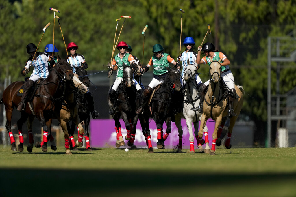 Players from Ireland and Argentina ride their horses during a match for the Women's Polo World Championship