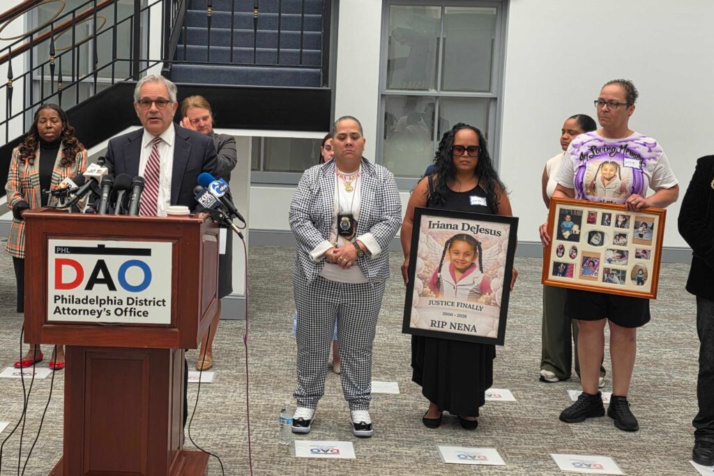krasner-2026-09-01 Larry Krasner speaks at a podium surrounded by others