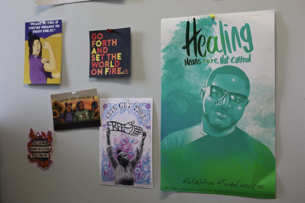 On the wall, several posters are hanging featuring inspirational quotes.