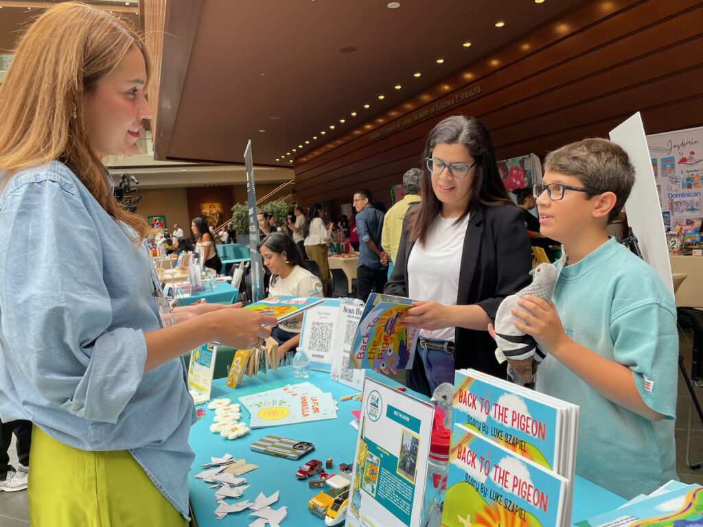 Luke Szapiel, right, talks about the children's book he authored, "Back to the Pigeon," at the eighth annual Philadelphia Latin American Book Festival