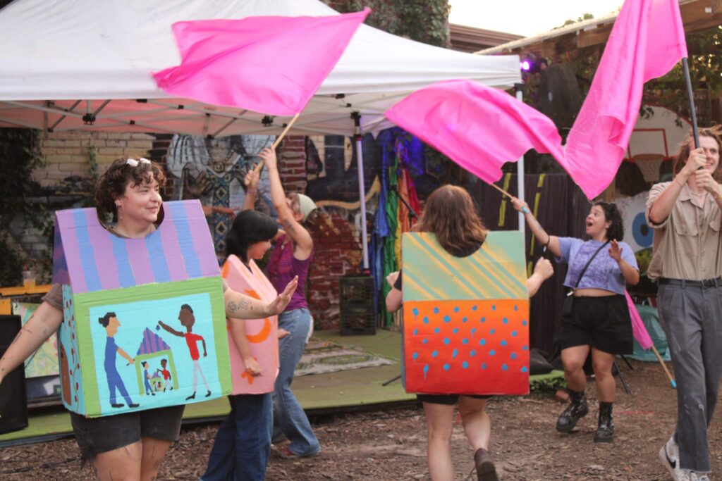 Puppet karaoke participants dance along to a karaoke performance
