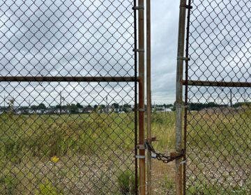 a vacant site behind a gate