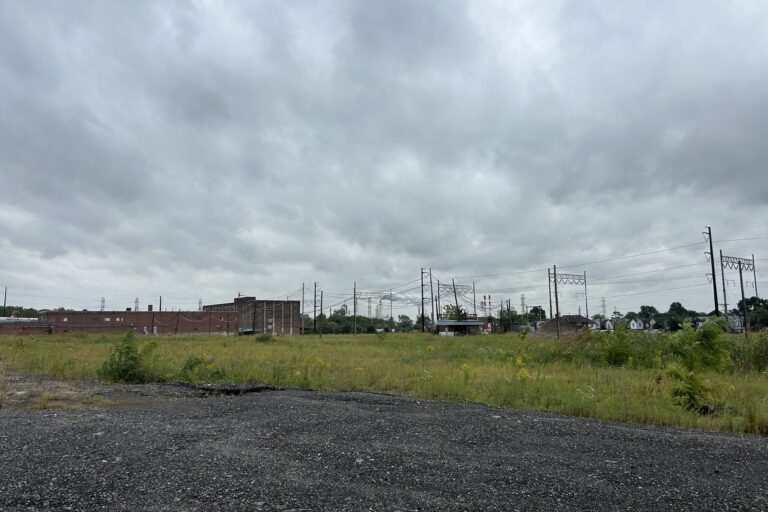 a vacant site of grass and gravel