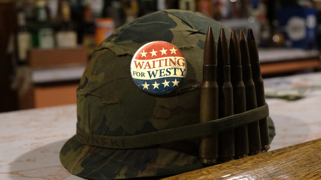 waiting-for-westy-promo-photo-helmet a military helmet holds bullets and a pin reading WAITING FOR WESTY