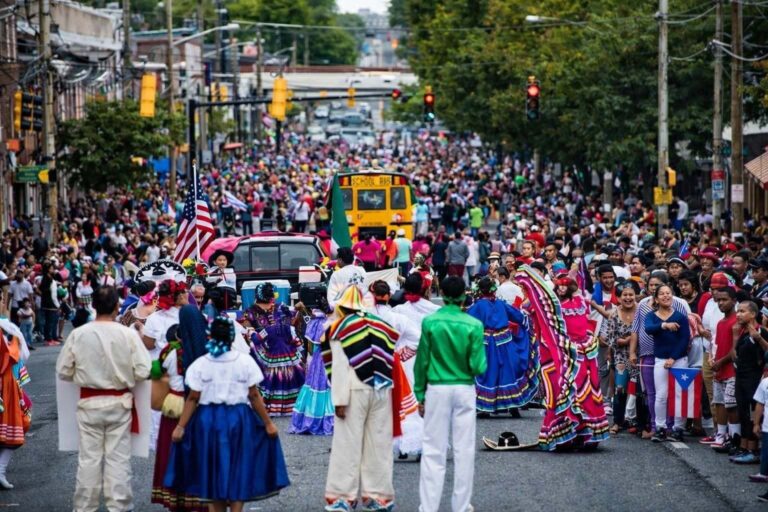 A massive crowd of people fill the street.