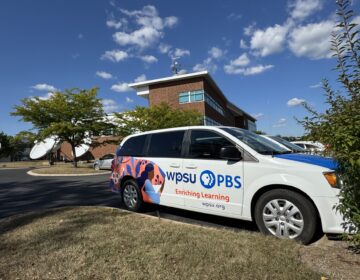 A WPSU van sits outside the station's headquarters