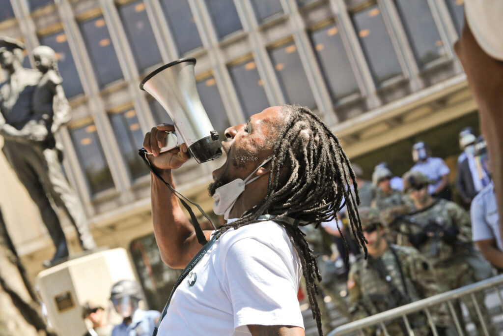 Hassan Bennett speaks into a megaphone