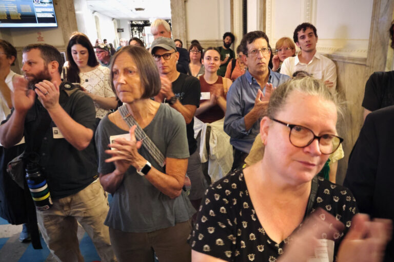 Protesters marching and clapping in City Hall