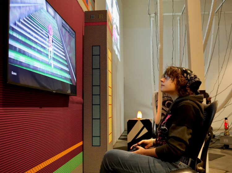 Corrina Mullins playing a video game at the Drexel video game exhibition in Philadelphia