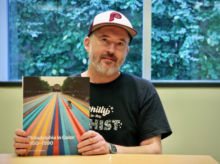 Peter Woodall holds his book