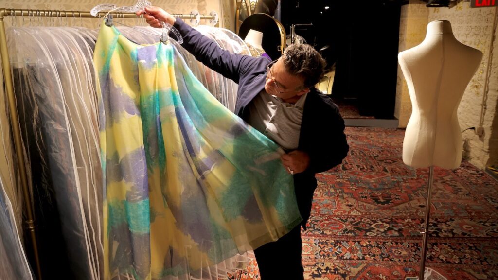 2026 10 12-e lee-william valerio-philadelphia woodmere art museum-mary mcfadden lending library silk chiffon skirt William Valerio inspects displayed skirt for photo