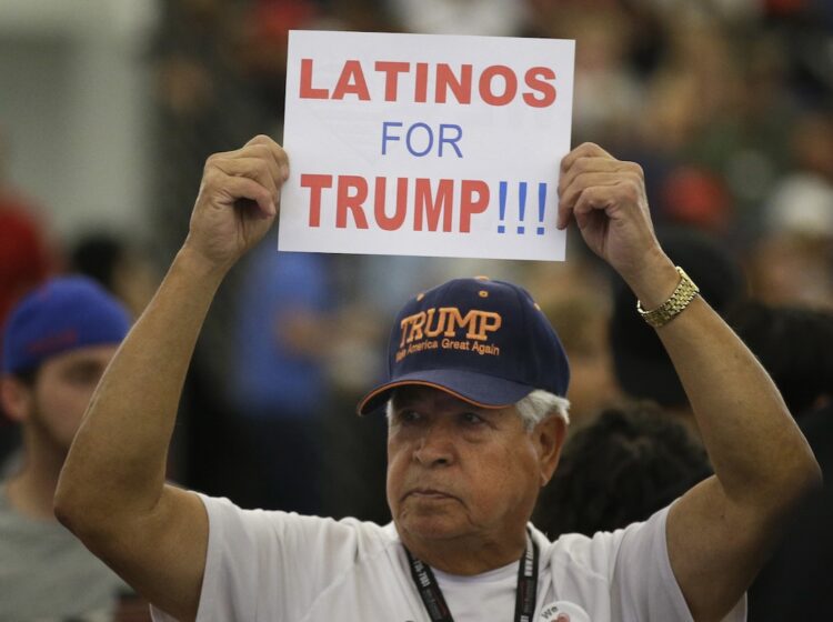 A Hispanic man holds up a sign for Republican presidential candidate Donald Trump before the start of a rally at the Anaheim Convention Center, Wednesday, May 25, 2016, in Anaheim, Calif. (AP Photo/Jae C. Hong)