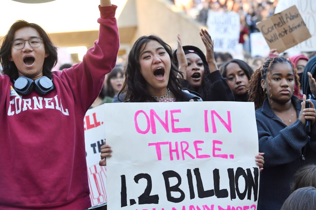 Demonstrators attend a protest against Cornell University's handling of the 2024 fraternity-house gang rape allegations at the campus, Monday, Oct. 5, 2026, in Ithaca, N.Y. (AP Photo/Adrian Kraus)