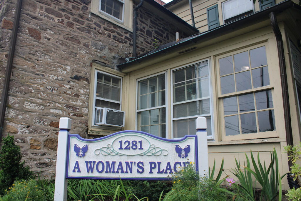an entrance sign reads 1281 A Woman's Place