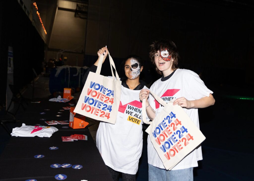 Students holding up signs for the 'Party to the Polls' event.