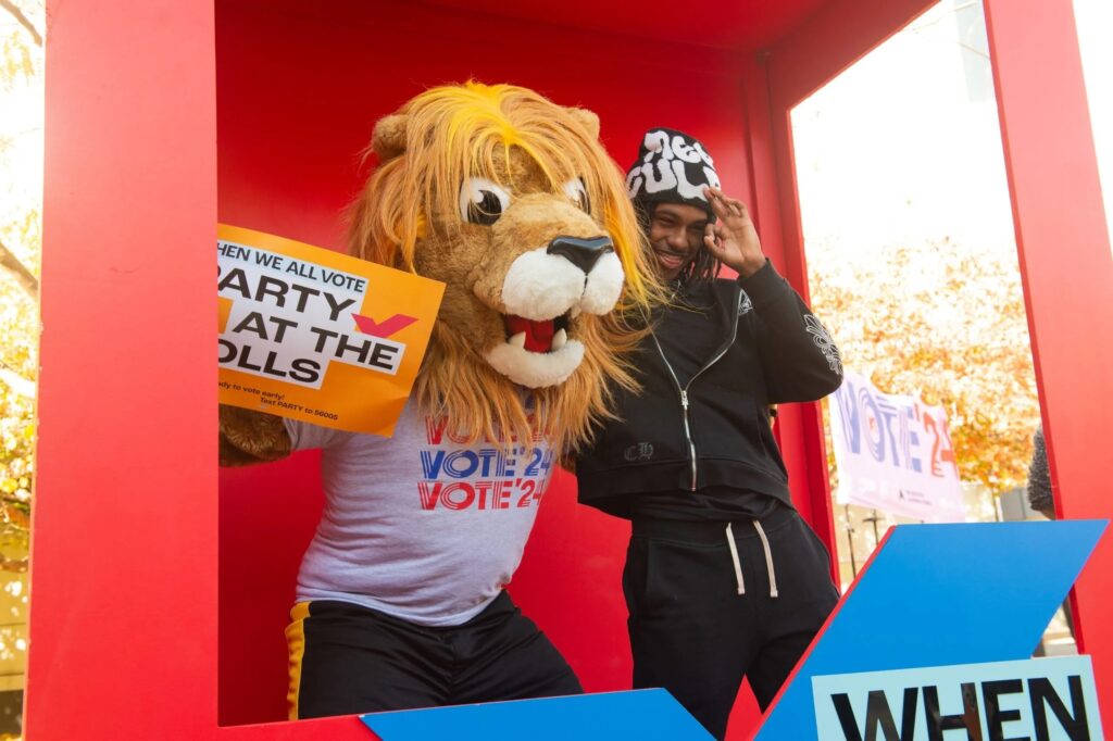 Students holding up signs for the 'Party to the Polls' event.
