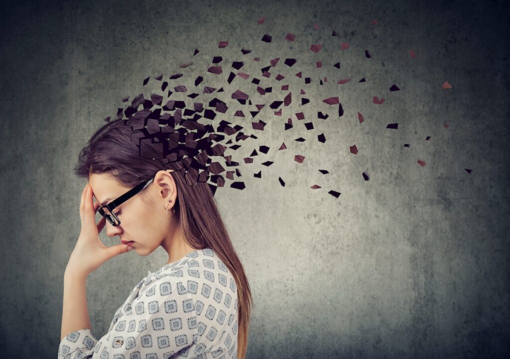 Memory Loss Due To Dementia Or Brain Damage. Young Woman Losing Parts Of Head As Symbol Of Decreased (Feodora/Bigstock)