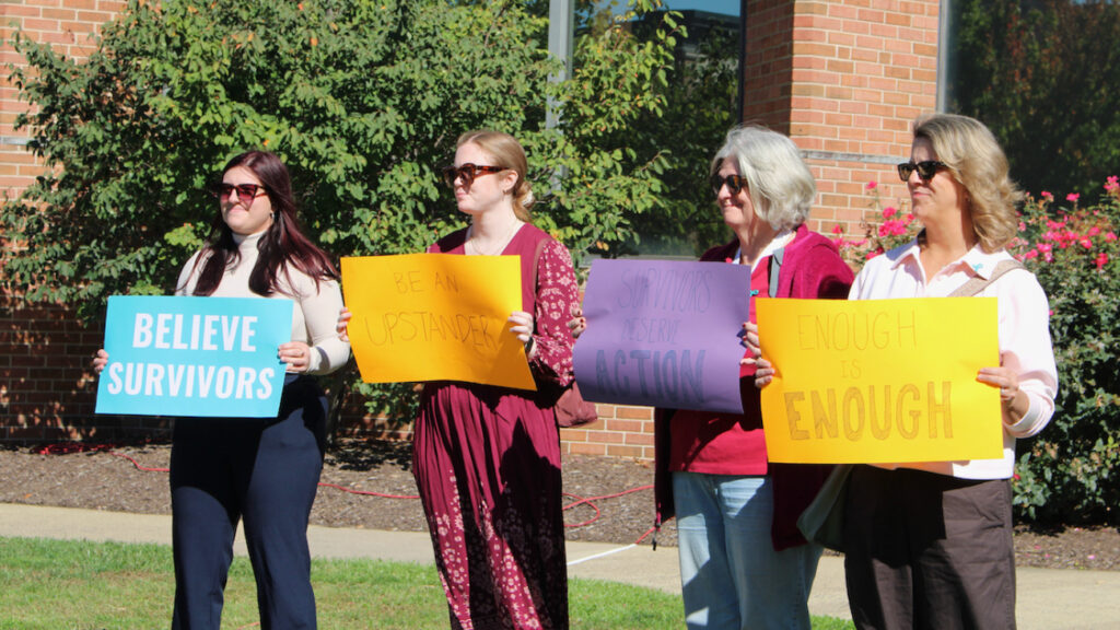 bucks-county-rally-against-sexual-violence-1-cropped-newest four women hold signs reading BELIEVE SURVIVORS, BE AN UPSTANDER, SURVIVORS DESERVE ACTION, AND ENOUGH IS ENOUGH