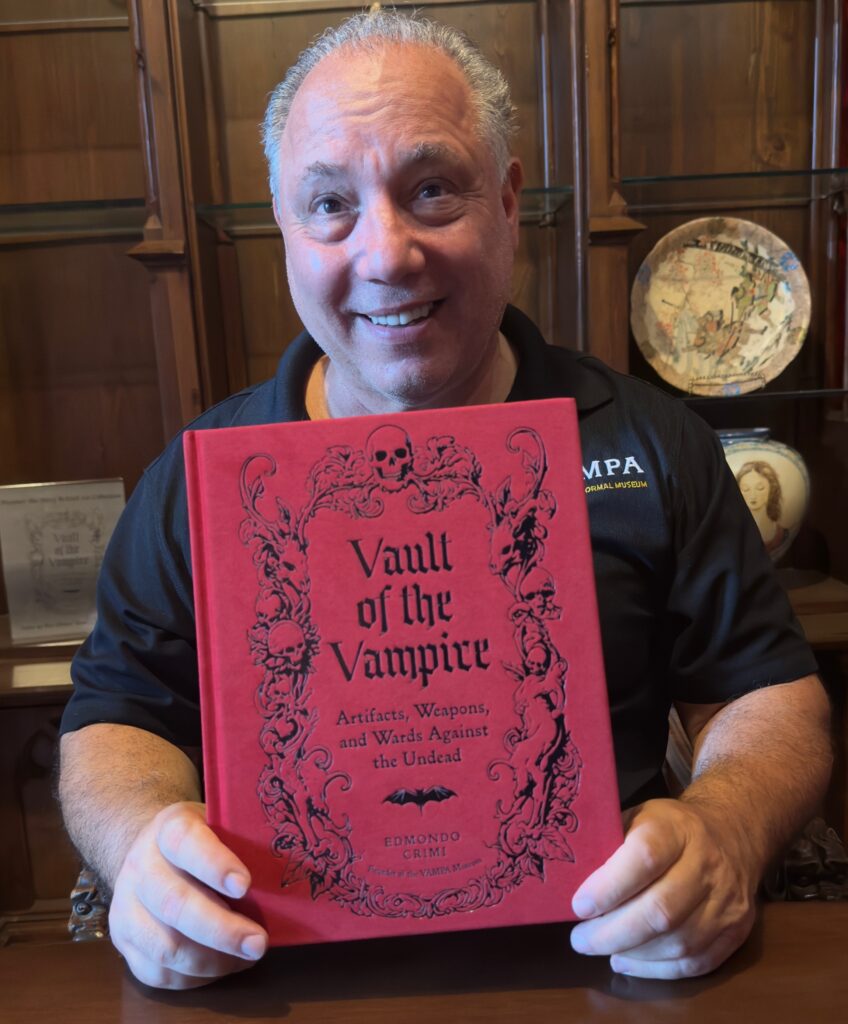 Edmondo Crimi holds a copy of his book