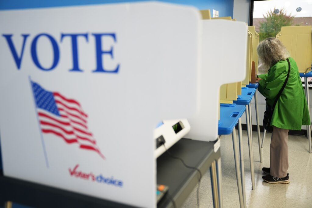 A voter casts a ballot at their polling place on Election Day