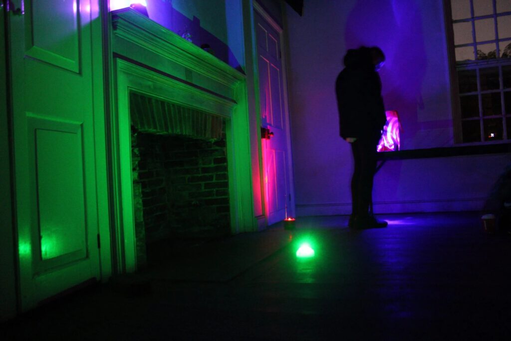 fort-mifflin-haunted-tour-2026-bp a person stands in a dark room