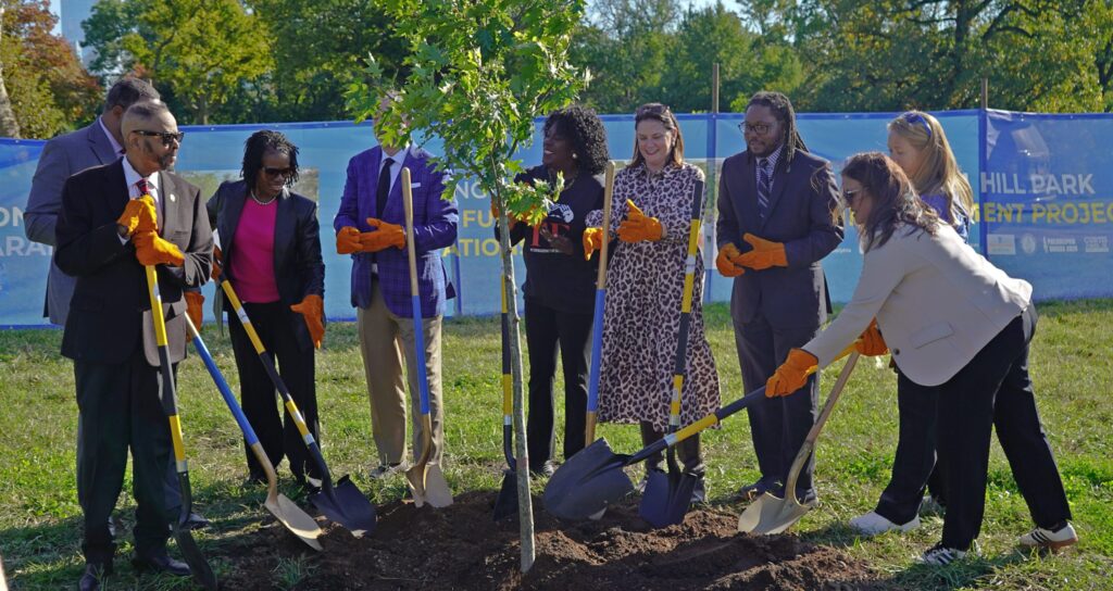 City officials, FIFA World Cup organizers and sponsors, and park volunteers plant the first new tree