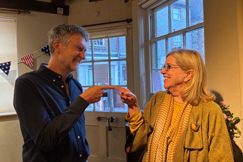 Adrian Ross and Amy Marasco touch fingers