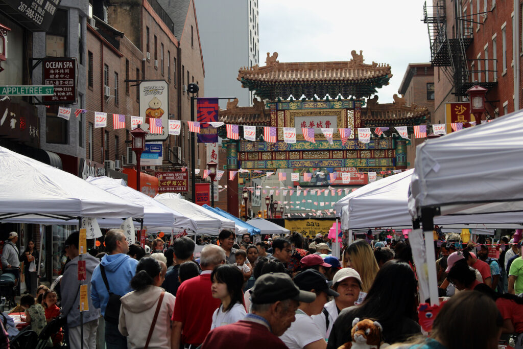 A large crowd of people in Philadelphia's Chinatown neighborhood