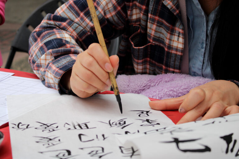 A man drawing caligraphy
