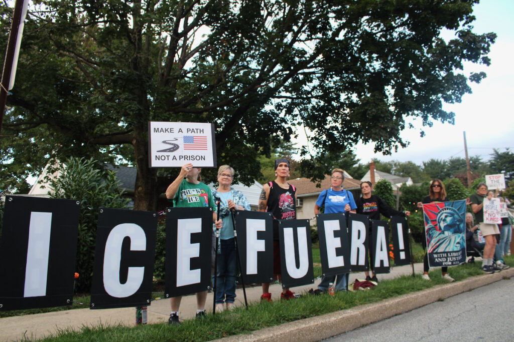 norristown-ice-protest-september-2026-6 Several people are shown holding up handmade signs while standing on the side of the road for the anti-ICE protest in Norristown.