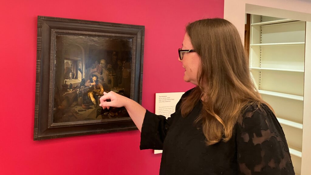 Elisabeth Berry Drago points at a painting