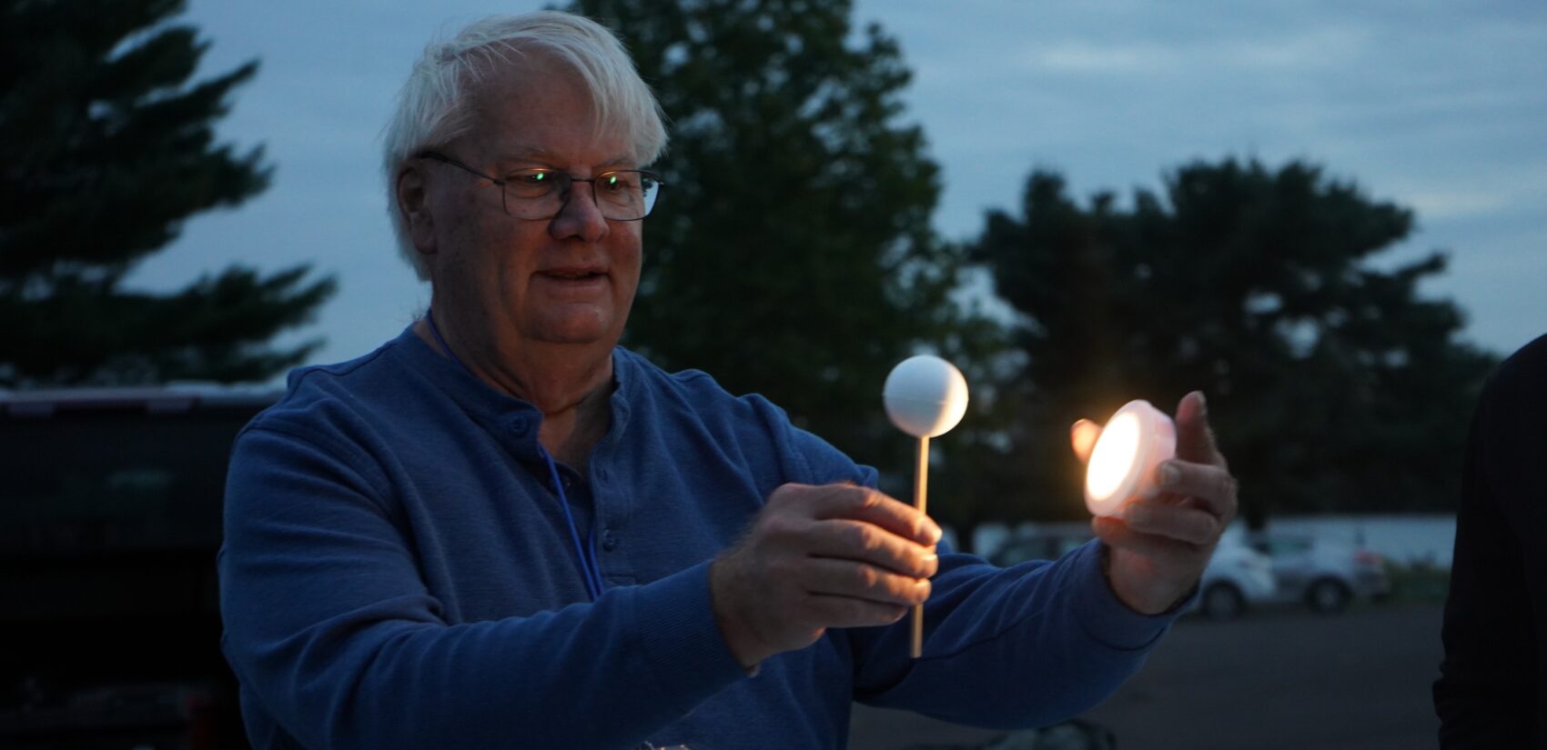 Dwight Dulsky bounces light off a ball on a stick