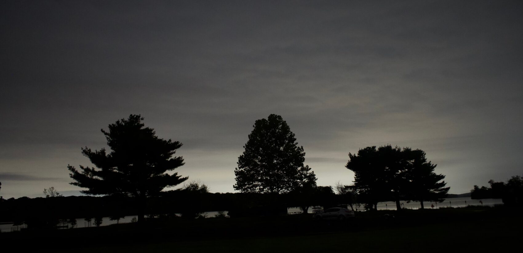 a long-exposure image of the tree line surrounding Lake Nockamixon
